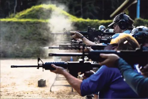  ?? Getty Images ?? Students fire AR-15 semi-automatic rifles during a shooting course at Boondocks Firearms Academy in Jackson, Miss., on Sept. 26. From the countrysid­e to the cities, Americans are engaged in a frenzy of gun-buying fueled by the pandemic, protests and politics.