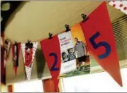  ??  ?? A string of flags hangs in the Lewis' dining room from the 25th anniversar­y party of Jeffrey's brain operation, which freed him from seizures.