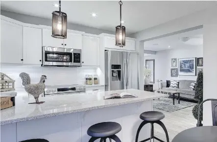  ?? MATTAMY HOMES ?? The popular trend in townhome kitchens is an island or breakfast bar flowing into the rest of the living space.