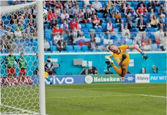  ?? — AFP ?? Russia striker Aleksey Miranchuk (not seen in picture) scores the only goal past Finland goalkeeper Lucas Hradecky during their Euro 2020 Group B match in Saint Petersburg, Russia, yesterday. The result moves Stanislav Cherchesov’s side up to second in the standings on three points, ahead of Finland thanks to the head-tohead result. Belgium tops the group ahead of its game against Denmark.