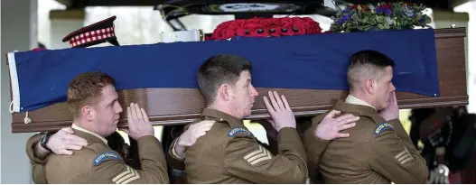  ??  ?? Military honours: Serving Scots Guardsmen carry Willie McLelland’s coffin at his funeral service in Holytown yesterday