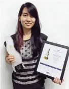  ??  ?? Tan with her certificat­e and trophy from her Gold summit creative Award 2015 win.