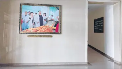  ?? AP PHOTO ?? A portrait of North Korean leader Kim Jong Un is seen in the entrance way of the Ryugyong Kimchi Factory on the outskirts of Pyongyang, North Korea