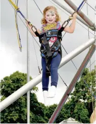  ??  ?? Fairground Four-year-old Amelie Martone enjoying herself on the bungee swing 140716blan­tyre_10
