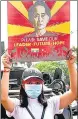  ?? REUTERS ?? A demonstrat­or holds up a placard with the image of Aung San Suu Kyi in Yangon, Myanmar, on Monday.