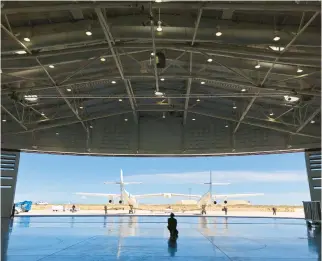 ?? SUSAN MONTOYA BRYAN/AP FILE ?? Virgin Galactic ground crew guide the company’s carrier plane into the hangar at Spaceport America following a test flight over the desert near Upham, New Mexico, on Aug. 15, 2019. The space flight company’s revenue in the past four quarters was $1.6 million.