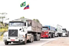  ?? — AFP photo ?? Brazilian trucks which were withheld in Venezuelan territory cross from Venezuela to Pacaraima, Roraima state, Brazil.