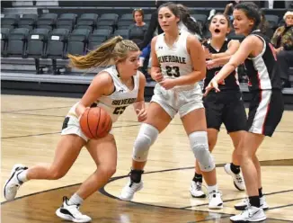  ?? STAFF PHOTOS BY PATRICK MACCOON ?? Silverdale Baptist sophomore Kelsie Johnson drives down the lane thanks to a pick set by teammates Tori Gibson. Johnson scored 25 points in the season opening win over Signal Mountain at the Silverdale Center on Tuesday.