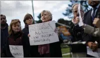  ?? DAI SUGANO — STAFF ARCHIVES ?? Homeless advocate Gail Osmer, center, holds a sign at the Westwinds Mobile Home Park in San Jose on Jan. 9.