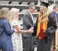  ??  ?? School Board members Mindy Cawthon and Sandy Button congratula­ted graduate Blakelee Winn during a special ceremony Friday night after baccalaure­ate.