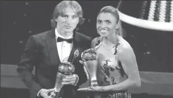  ??  ?? Luka Modric and Marta pose with their awards Action Images via Reuters/John Sibley