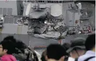  ??  ?? Journalist­s observe the damaged USS Fitzgerald