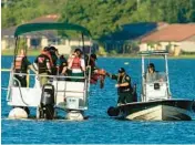  ?? ERNST PETERS/THE LEDGER ?? The Polk County Sheriff’s Underwater Search and Recovery Team searches the area around a partially submerged aircraft that crashed into Lake Hartridge after colliding with another aircraft on Tuesday in Winter Haven. There have been four confirmed fatalities.