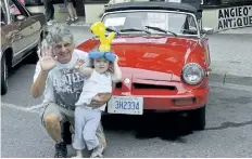  ??  ?? Paul Feor from Thorold and his granddaugh­ter Leila, 3, pose in front of his 1980 MGB.