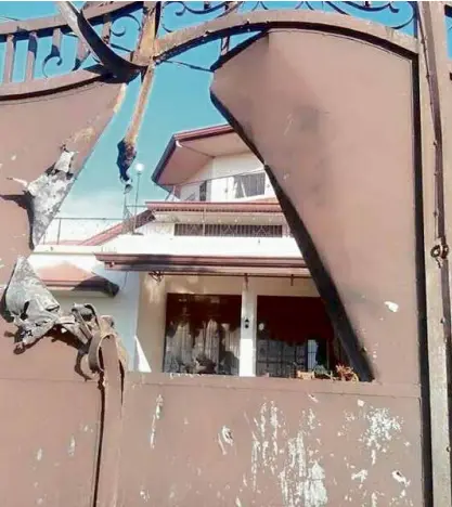  ?? —DRIES ABATO LININDONG ?? Aside from an Islamic school, this house in Matanao town was also hit by mortar fire that punched a hole on its gate. The stray mortar round was fired by terrorists still holed up in Marawi, according to the military.