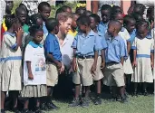  ??  ?? Right: Prince Harry arriving in Antigua last month and, left, meeting school children after a boat trip on the island of Barbuda; below, his girlfriend, Meghan Markle