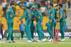  ?? — AFP ?? Pakistan players celebrate at the end of the first T20 match against New Zealand at the Abu Dhabi Cricket Stadium.