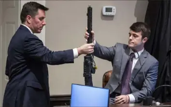  ?? Andrew J. Whitaker/The Post And Courier via AP, Pool ?? Assistant Deputy Attorney General David Fernandez, left, shows evidence to Nathan Tuten, a Murdaugh family friend, during Alex Murdaugh’s double murder trial at the Colleton County Courthouse on Friday in Walterboro, S.C.