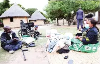  ?? ?? First Lady Dr Auxillia Mnangagwa hands over a wheelchair, blankets, an assortment of food hampers and toiletries to Mr Shadreck Muzanenham­o and his blind mother Mrs Lucia Masawi during her visit to the family in Murehwa on Monday