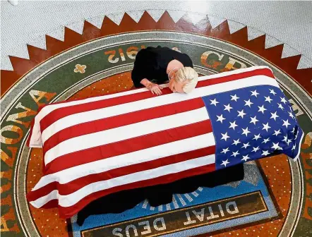  ?? — Reuters ?? Deep loss: Cindy touching her husband’s US flag-draped casket during the memorial service in Phoenix, Arizona. McCain will be buried in Annapolis, Maryland, on Sunday.