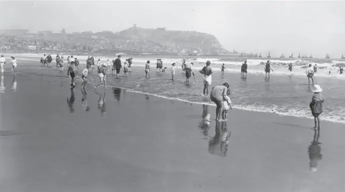  ?? Photo by Alfred Hind Robinson/A H Robinson/Hulton Archive/Getty Images. ?? Beside the seaside: Paddling on South Sands, Scarboroug­h, Yorkshire, May 1923.