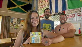  ?? ROSS GIBLIN/STUFF ˘ ?? Overseas visitors, from left, Alex Brammer, Darren Mollaghan and Matthew Zimerman buy Lotto scratch tickets.