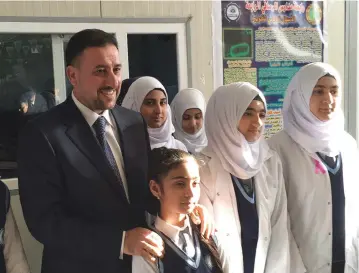  ?? (Ned Parker/Reuters) ?? KHAMIS KHANJAR, a Sunni multimilli­onaire, visits displaced Sunni Iraqis at a school he funds in Iraqi Kurdistan.