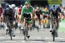  ?? Photograph: Christophe Petit-Tesson/EPA ?? Mark Cavendish of the Deceuninck Quick-Step team celebrates as he crosses the finish line to win the 13th stage of the Tour de Frances