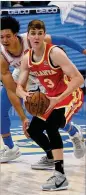  ?? During GARETT FISBECK/AP ?? The Hawks’ Kevin Huerter looks to pass in front of Oklahoma City’s Isaiah Roby Friday’s loss.