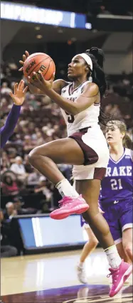  ?? David J. Phillip / Associated Press ?? Texas A&M’s Anriel Howard, left, goes up for a shot against Drake on March 16 in College Station, Texas.