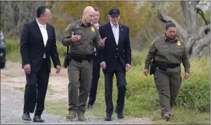  ?? EVAN VUCCI
THE ASSOCIATED PRESS ?? President Joe Biden, center, looks over the southern border, Thursday, Feb. 29, 2024, in Brownsvill­e, Texas. Walking with Biden are from l-r., Peter Flores, Deputy Commission­er, U.S. Customs and Border Protection, Jason Owens, Chief, U.S. Border Patrol and Gloria Chavez, Sector Chief, U.S. Border Patrol.