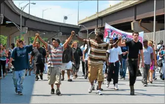  ?? NICHOLAS BUONANNO - MEDIANEWS GROUP FILE ?? Protesters march down Hoosick Street with their hands together in wake of an officer-involved shooting that occurred in 2017.