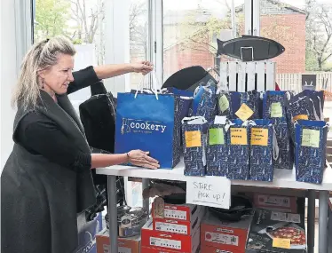  ?? RICHARD LAUTENS TORONTO STAR ?? Alison Fletcher, the owner of Cookery, a kitchenwar­e store on Roncesvall­es, has been doing curbside pick-up since late March and says the official opening on Monday hasn't made a huge difference.