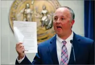  ?? AP FILE PHOTO BY CHRIS SEWARD ?? In this 2017 photo, North Carolina House Democratic leader Darren Jackson holds up a copy of HB 186, which was a compromise bill to replace HB 2, in Raleigh, N.C.