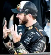  ?? AP/ED ZURGA ?? Martin Truex Jr.
shows the number of races won this season as he celebrates his seventh NASCAR Monster Energy Cup Series victory on Sunday in Kansas City, Kan. Truex leads the points standings entering the third playoff round.