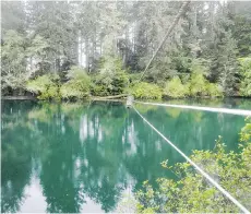  ??  ?? A pulley system whisks hikers over water on the West Coast Trail.