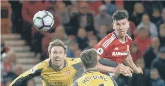  ??  ?? Boro’s Daniel Ayala wins a header ahead of Arsenal’s Nacho Monreal.