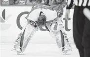  ?? NICK WASS/ASSOCIATED PRESS ?? Capitals goaltender Braden Holtby leans over after taking a stick to the eye during an overtime loss Saturday night.