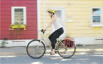  ?? PAUL DARROW/NATIONAL POST ?? NDP deputy leader and environmen­t critic Megan Leslie, riding her bike in Halifax, faces Liberal Andy Fillmore.