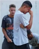  ?? Reuters ?? A boy cries as people wait for informatio­n near the training centre of Rio’s soccer club Flamengo in Rio de Janeiro, Brazil.—