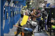  ?? JEFF KOWALSKY — BLOOMBERG ?? Employees work on the assembly line at the Dakkota Integrated Systems manufactur­ing facility in Detroit on May 5.