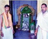  ??  ?? Priests stand before the idol of Lord Anjaneya.