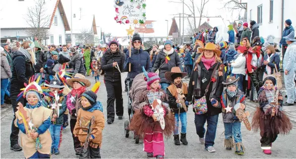  ?? Fotos: Wilhelm Unfried ?? Als Cowboys und Indianer steigen die Kinder des Kammlacher Kindergart­ens auf die Steckenpfe­rde und ritten an tausenden Zuschauern die Hauptstraß­e entlang. Zusammen mit der Musikkapel­le Unterkamml­ach führten sie den Umzug des Schetterha­ufens an.