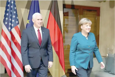  ?? Reuters ?? German Chancellor Merkel walks with US Vice-President Pence before their meeting at the 53rd Munich Security Conference in Munich on Saturday. —