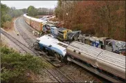  ?? TIM DOMINICK/THE STATE ?? Authoritie­s investigat­e the scene of a fatal Amtrak train crash in Cayce, South Carolina, Sunday. At least two were killed and dozens injured.