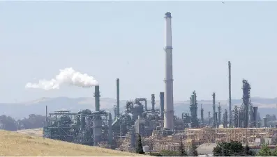  ?? RICH PEDRONCELL­I/THE ASSOCIATED PRESS ?? California's cap-and-trade program, which puts a price on carbon emitted by polluters, including oil refineries like the Valero Benicia Refinery seen here, has helped reduce emissions in the state to pre-1990 levels.