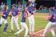  ?? Gene J. Puskar / Associated Press ?? Michigan pitcher Jakob Furkas (18) celebrates with teammates after the final out in the team’s 2-1 win over Honolulu at the Little League World Series in South Williamspo­rt, Pa., on Saturday.