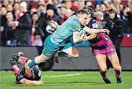  ??  ?? Lunge for the line: Rory Scannell forces his way past Gloucester’s Ed Slater and Callum Braley to score Munster’s second try