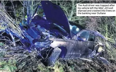  ??  ?? The Audi driver was trapped after his vehicle left the M62 J23 exit sliproad and crashed into trees on the banking near Outlane