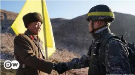  ??  ?? Soldiers from North and South Korea verify the removal of guard posts on each side of the Demilitari­zed Zone